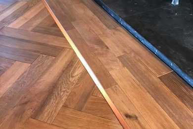 herringbone hardwood with a inlayed copper boarder