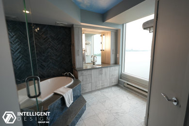 Bathroom - blue tile and ceramic tile marble floor, multicolored floor and single-sink bathroom idea in Toronto with flat-panel cabinets, light wood cabinets, a two-piece toilet, gray walls, an undermount sink, quartz countertops, a hinged shower door, gray countertops and a built-in vanity