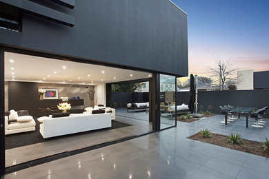 Photo of a modern family room in Christchurch with ceramic floors.