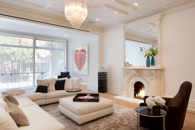 Example of a trendy living room design in New York with white walls and a standard fireplace