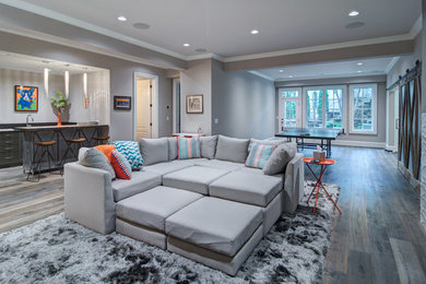 Basement - large modern walk-out medium tone wood floor basement idea in Atlanta with gray walls