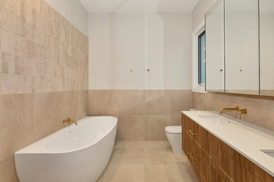 Mid-sized minimalist beige tile double-sink drop-in bathtub photo in Melbourne with a drop-in sink, marble countertops, white countertops and a built-in vanity