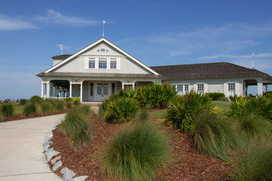 Example of a beach style home design design in Charleston