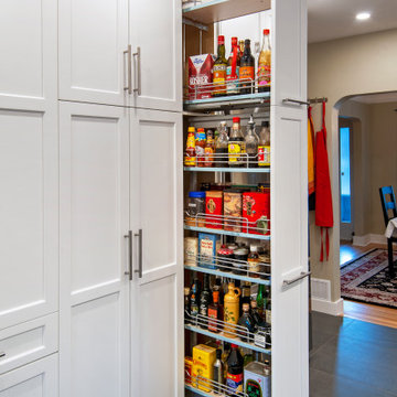 Functional & Stylish White Kitchen with Dark Countertops and Backsplash