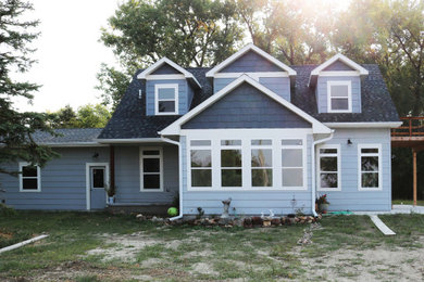 Beach style blue two-story exterior home photo in Other