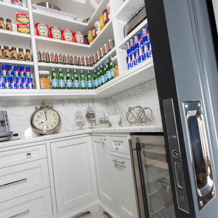 Large contemporary u-shaped kitchen pantry in Toronto with beaded inset cabinets, white cabinets, marble benchtops, grey splashback, stone slab splashback, stainless steel appliances, with island, white floor and porcelain floors.