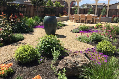 This is an example of a mid-sized eclectic backyard full sun xeriscape in San Francisco with a water feature and gravel.