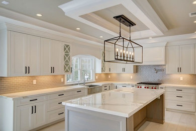 Large transitional light wood floor and gray floor eat-in kitchen photo in New York with a farmhouse sink, recessed-panel cabinets, white cabinets, quartz countertops, beige backsplash, porcelain backsplash, stainless steel appliances and an island