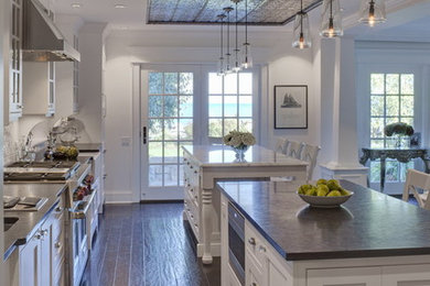 Inspiration for a large transitional u-shaped dark wood floor eat-in kitchen remodel in Richmond with white cabinets, two islands, a double-bowl sink, shaker cabinets, granite countertops, white backsplash, subway tile backsplash and stainless steel appliances