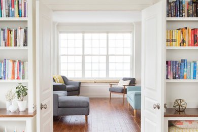 Example of a small transitional enclosed dark wood floor living room library design in Philadelphia with white walls, no fireplace and no tv