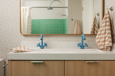 Example of a mid-sized mid-century modern 3/4 multicolored floor, single-sink and wallpaper bathroom design in Salt Lake City with flat-panel cabinets, light wood cabinets, a two-piece toilet, a trough sink, quartz countertops, white countertops and a floating vanity