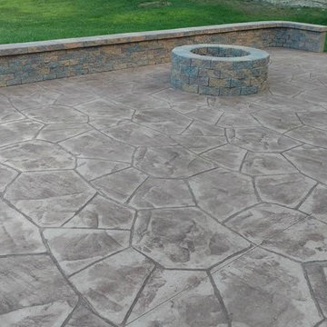 Stamped concrete patio with block seating wall and block fire-pit