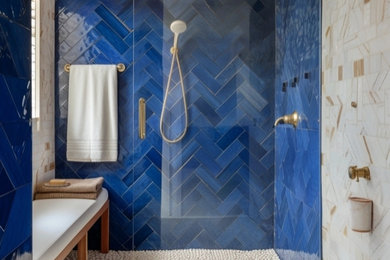 Bathroom - mid-sized modern blue tile and glass tile bathroom idea in Miami with glass-front cabinets