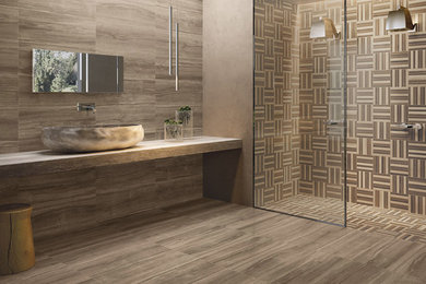 Photo of a mid-sized contemporary master bathroom in Seattle with porcelain tile, grey walls, porcelain floors, open cabinets, light wood cabinets, an alcove shower, brown tile, a vessel sink and wood benchtops.