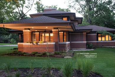 Inspiration for a mid-sized transitional multicolored brick house exterior remodel in Chicago with a hip roof and a shingle roof