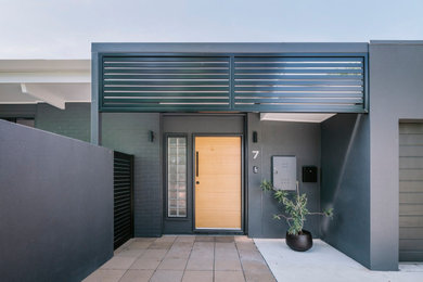 Midcentury two-storey brick black exterior in Townsville.