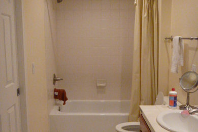 Example of a small minimalist kids' gray tile and ceramic tile ceramic tile bathroom design in Seattle with an undermount sink, flat-panel cabinets, gray cabinets, quartzite countertops, a two-piece toilet and beige walls
