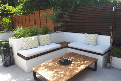 Photo of a medium sized modern back patio in London.