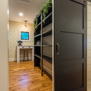Large transitional kitchen pantry remodeling - Kitchen pantry - large transitional medium tone wood floor kitchen pantry idea in Cedar Rapids with open cabinets, black cabinets and no island