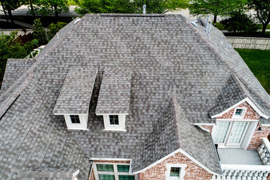 Inspiration for a two-story house exterior remodel in Austin with a shingle roof