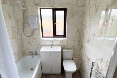 Photo of a small contemporary family bathroom in Other with freestanding cabinets, white cabinets, an alcove bath, a shower/bath combination, a two-piece toilet, multi-coloured tiles, porcelain tiles, multi-coloured walls, vinyl flooring, a console sink, multi-coloured floors, a shower curtain, a single sink and a freestanding vanity unit.