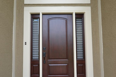 Photo of a contemporary front door in Kansas City with a single front door and a dark wood front door.