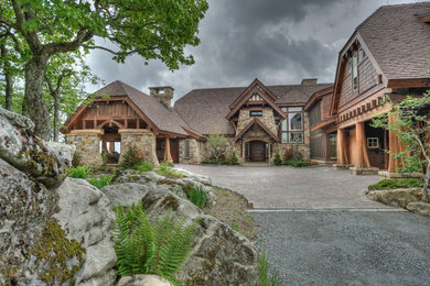 Example of a huge mountain style two-story mixed siding exterior home design in Charlotte with a clipped gable roof