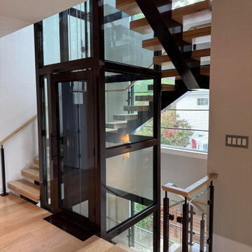 Project #136 | Modern Floating Staircase Encircling Glass Elevator