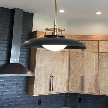 Angled Kitchen Design with Slab Style Cabinets in Pecan Stain