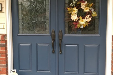 This is an example of a traditional front door in New York with a double front door and a blue front door.