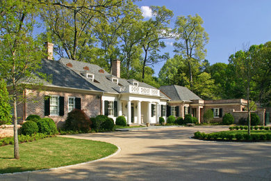 Photo of a large traditional two-storey white house exterior in Other with mixed siding, a hip roof and a shingle roof.