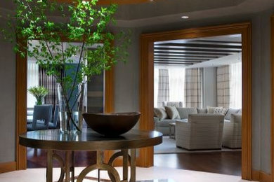 Inspiration for a large modern marble floor entryway remodel in DC Metro with gray walls and a dark wood front door