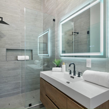 Wood-Grain Tile Shower with Frameless Glass Return