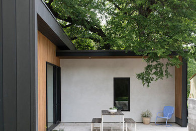 Example of a small backyard concrete paver patio design in Austin with no cover