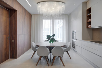 Trendy porcelain tile, beige floor and wainscoting dining room photo in Saint Petersburg with beige walls