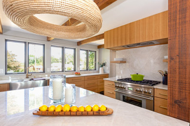 Eat-in kitchen - mid-sized 1960s terrazzo floor, black floor and exposed beam eat-in kitchen idea in Other with a farmhouse sink, flat-panel cabinets, light wood cabinets, quartzite countertops, beige backsplash, stone slab backsplash, stainless steel appliances, an island and beige countertops