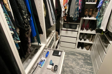 Small transitional gender-neutral carpeted built-in closet photo with open cabinets and white cabinets