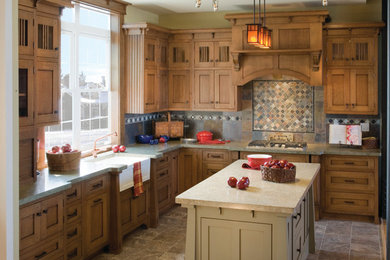 Mid-sized arts and crafts l-shaped ceramic tile and brown floor kitchen photo in Chicago with a farmhouse sink, shaker cabinets, medium tone wood cabinets, multicolored backsplash, stone tile backsplash and an island