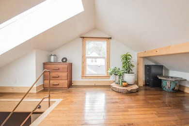 Bedroom - mid-sized rustic guest light wood floor and brown floor bedroom idea in Portland with white walls and no fireplace