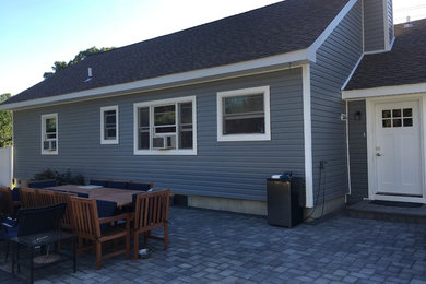 Inspiration for a mid-sized timeless blue one-story vinyl gable roof remodel in New York