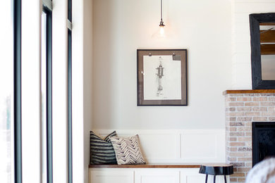 Inspiration for a mid-sized transitional open concept laminate floor and brown floor living room remodel in Other with gray walls, a standard fireplace, a brick fireplace and a wall-mounted tv