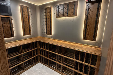 Example of a mid-sized minimalist porcelain tile wine cellar design in Cincinnati