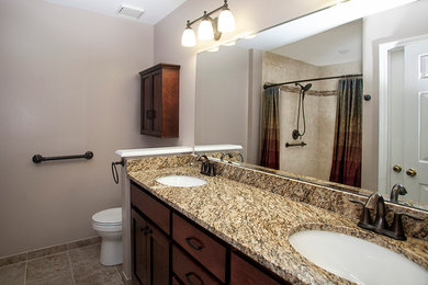 Double shower - large transitional master multicolored tile and cement tile ceramic tile double shower idea in Louisville with an undermount sink, furniture-like cabinets, medium tone wood cabinets, granite countertops, a two-piece toilet and beige walls