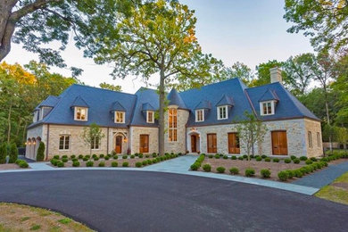 Huge eclectic gray two-story stone house exterior photo in Chicago