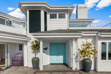 Inspiration for a large coastal two-story exterior home remodel in Orange County