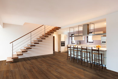 Example of a mid-sized minimalist galley dark wood floor and brown floor open concept kitchen design in Phoenix with an undermount sink, flat-panel cabinets, white cabinets, stainless steel appliances and a peninsula