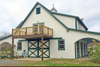 Example of a large farmhouse beige two-story vinyl gable roof design in Baltimore