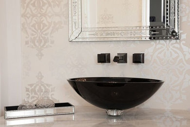 This is an example of a mid-sized traditional powder room in Toronto with a vessel sink and marble benchtops.