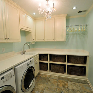Inspiration for a medium sized shabby-chic style l-shaped separated utility room in Kansas City with a built-in sink, raised-panel cabinets, white cabinets, composite countertops, blue walls, a side by side washer and dryer, laminate floors and multi-coloured floors.