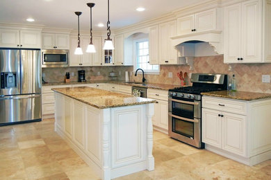 Enclosed kitchen - large contemporary l-shaped porcelain tile enclosed kitchen idea in New York with an undermount sink, raised-panel cabinets, beige cabinets, granite countertops, stone tile backsplash, stainless steel appliances and an island